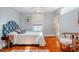 Bright bedroom with hardwood floors, ceiling fan, and private entry at 319 W Margaret Ln, Hillsborough, NC 27278
