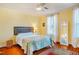 Bedroom with natural light, a ceiling fan, hardwood floors, and comfortable furnishings at 319 W Margaret Ln, Hillsborough, NC 27278