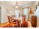 Inviting dining room with warm wood floors and decorative accents and seating for six at 319 W Margaret Ln, Hillsborough, NC 27278