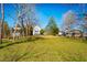 Spacious front yard and view of multiple homes on the property on a sunny day at 319 W Margaret Ln, Hillsborough, NC 27278