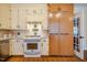 Charming kitchen featuring tile flooring, bright white cabinetry, and stainless steel appliances at 319 W Margaret Ln, Hillsborough, NC 27278