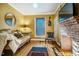 Eclectic living room with brick fireplace, gold walls, comfortable seating, and hardwood floors at 319 W Margaret Ln, Hillsborough, NC 27278