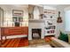 Cozy living room with a brick fireplace, and built-in shelving at 319 W Margaret Ln, Hillsborough, NC 27278