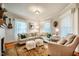Bright living room with a comfortable sofa, large rug, and lots of natural light at 319 W Margaret Ln, Hillsborough, NC 27278