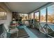 Inviting screened-in porch with comfortable seating and charming decor on a blue painted floor at 319 W Margaret Ln, Hillsborough, NC 27278