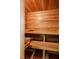 An inviting wooden sauna with built-in benches, featuring a bucket and ladle for an authentic experience at 319 W Margaret Ln, Hillsborough, NC 27278