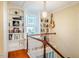 Stairway landing with built-in bookshelves, natural light, and decorative accents at 319 W Margaret Ln, Hillsborough, NC 27278