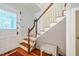 Inviting staircase with wood steps, white risers, and wood railing at 319 W Margaret Ln, Hillsborough, NC 27278