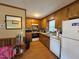 Functional kitchen with wood cabinets, white appliances, and a window above the sink at 322 Blackstone Rd, Sanford, NC 27330