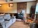 Comfortable living room with a brick fireplace, wood accents, and cozy furnishings at 322 Blackstone Rd, Sanford, NC 27330