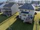 Aerial view of backyard with a deck, surrounded by a black fence and lush green grass at 3460 Willow Green Dr, Apex, NC 27502