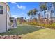 Expansive backyard with a deck and a black metal fence, set against a backdrop of tall trees at 3460 Willow Green Dr, Apex, NC 27502