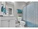 This bathroom has a blue patterned shower curtain and a toilet with a white vanity at 3460 Willow Green Dr, Apex, NC 27502