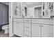 Neutral-toned bathroom features dual sinks and vanities with white cabinets and modern fixtures at 3460 Willow Green Dr, Apex, NC 27502