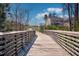 Scenic wooden bridge with community access to a single-Gathering home in a charming neighborhood with lush greenery at 3460 Willow Green Dr, Apex, NC 27502