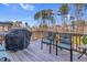 Outdoor deck featuring seating and grill, perfect for entertaining or relaxation in a tranquil setting at 3460 Willow Green Dr, Apex, NC 27502