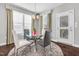 Cozy dining area with a glass-top table, stylish seating, and natural light from large windows at 3460 Willow Green Dr, Apex, NC 27502