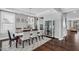Elegant dining room with a modern table set for a dinner party and a decorative display cabinet at 3460 Willow Green Dr, Apex, NC 27502