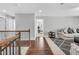 Bright hallway with wood floors, staircase and a view into the living room and office at 3460 Willow Green Dr, Apex, NC 27502