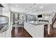 Open-concept kitchen with an island that offers seating and views to the dining and living areas at 3460 Willow Green Dr, Apex, NC 27502