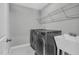 Functional laundry room featuring a washing machine, dryer, sink, and wire shelving at 3460 Willow Green Dr, Apex, NC 27502