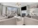 Inviting living room with a fireplace, plush seating, and a large window offering natural light at 3460 Willow Green Dr, Apex, NC 27502