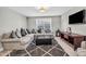 Spacious living room with large sectional sofa, carpet, and a TV for comfortable Gathering living at 3460 Willow Green Dr, Apex, NC 27502