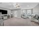 Living room with a sectional couch, natural light, and a large tv at 3460 Willow Green Dr, Apex, NC 27502