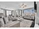Bright, open-concept living room with multiple seating areas and large windows for ample light at 3460 Willow Green Dr, Apex, NC 27502