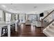 Open-concept living room with hardwood floors, neutral furniture, and natural light at 3460 Willow Green Dr, Apex, NC 27502