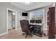 Comfortable office area with a desk, chair, and cabinets, adjacent to a well appointed bathroom at 3460 Willow Green Dr, Apex, NC 27502