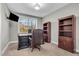 Well-lit office space with a large desk, leather chair, window, and dark wood bookshelves at 3460 Willow Green Dr, Apex, NC 27502