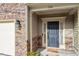 Home's inviting front entrance has decorative stonework, a black door, and a covered porch at 356 Westgrove Ct, Durham, NC 27703