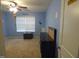Bright bedroom featuring blue walls, carpeted flooring, and ceiling fan at 401 Lawton Dr, Haw River, NC 27258