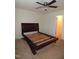 Bedroom with wood bed frame, neutral carpet, and ceiling fan with lights at 401 Lawton Dr, Haw River, NC 27258
