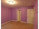 Carpeted bedroom featuring lavender walls and white trim at 401 Lawton Dr, Haw River, NC 27258