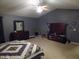 This spacious bedroom has carpet, a ceiling fan, and a dark gray color scheme at 401 Lawton Dr, Haw River, NC 27258