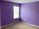 Bedroom featuring neutral carpet, purple painted walls and window at 401 Lawton Dr, Haw River, NC 27258