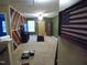 Open bonus room featuring carpeted floors and unique wood accent wall at 401 Lawton Dr, Haw River, NC 27258