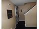 Entryway with staircase, neutral walls, dark floors, and patterned curtain at 401 Lawton Dr, Haw River, NC 27258