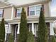 Charming two-story home with stone accents, red shutters, and meticulous landscaping at 401 Lawton Dr, Haw River, NC 27258