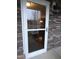Stone home featuring a white storm door and exterior lighting at 401 Lawton Dr, Haw River, NC 27258