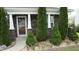 Charming front porch with stone accents and meticulously landscaped garden at 401 Lawton Dr, Haw River, NC 27258