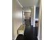 Hallway featuring hardwood floors and neutral-toned walls, providing a clean and transitional space in the home at 401 Lawton Dr, Haw River, NC 27258