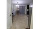 Bright kitchen with tile flooring, black cabinets, stainless steel fridge, and modern chandelier at 401 Lawton Dr, Haw River, NC 27258