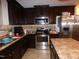 Kitchen featuring dark cabinets, stainless steel appliances and an island at 401 Lawton Dr, Haw River, NC 27258