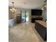 Open kitchen design with dark cabinetry, island, and sliding glass door to the backyard at 401 Lawton Dr, Haw River, NC 27258