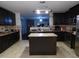 Kitchen with dark cabinets, stainless steel appliances and island at 401 Lawton Dr, Haw River, NC 27258