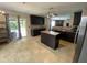 Bright kitchen area with dark cabinets, an island, and access to the patio at 401 Lawton Dr, Haw River, NC 27258