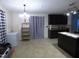 Spacious kitchen area with black cabinetry, a chandelier, and modern tile flooring at 401 Lawton Dr, Haw River, NC 27258